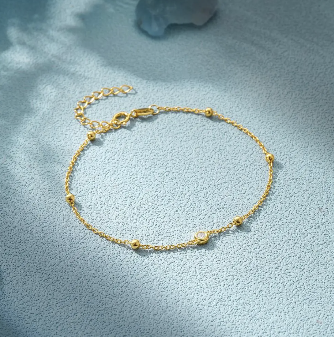 Bracelet plaqué or 18 carats avec œil et perles en zircone