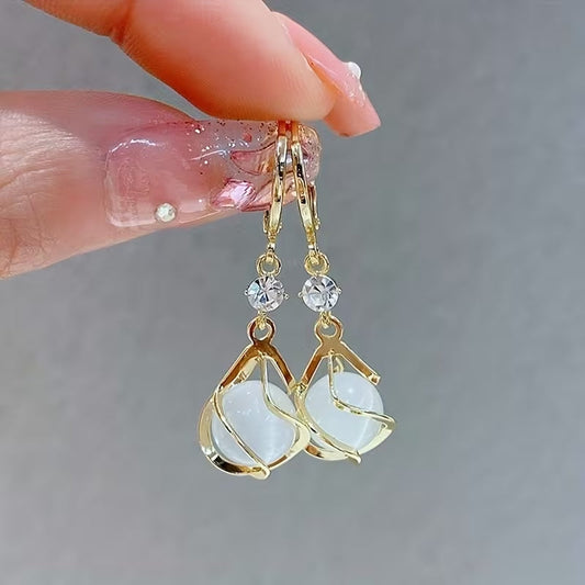 Boucles d'oreilles pendantes élégantes avec pompon et pierre