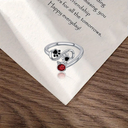 Bague Noire Empreinte Patte Réglable Avec Pierre Rouge