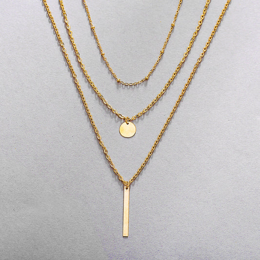 Collier vintage chaînes superposées avec pendentif géométrique